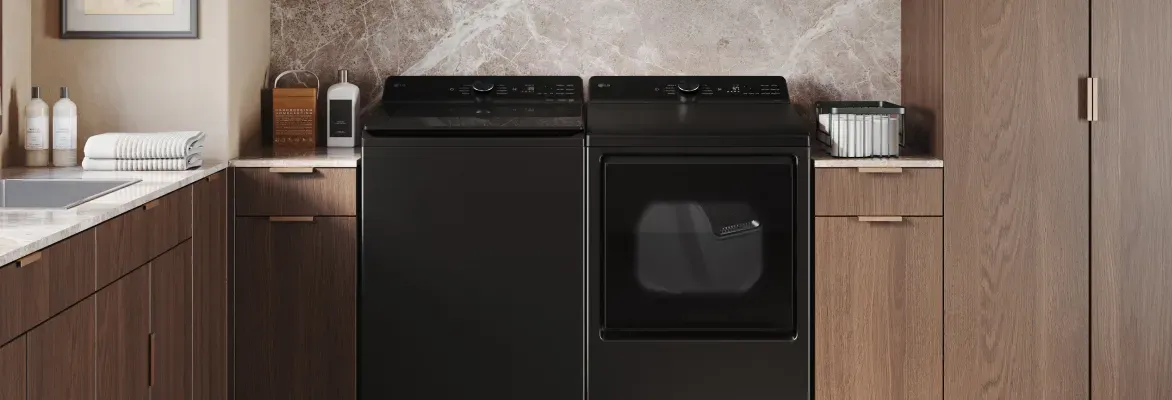 LG top load electric dryer and matching washer in a modern laundry room for family-sized loads.